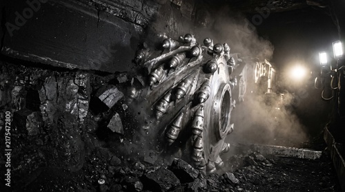 Obraz na płótnie A continuous miner cutting drum biting into a soft coal seam