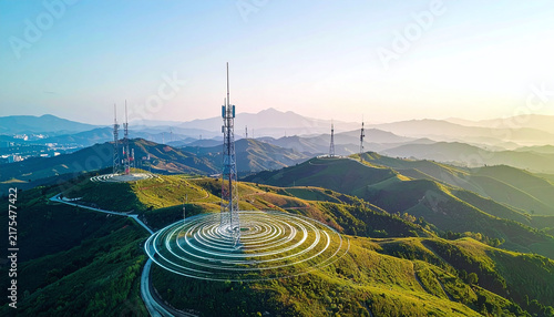 Aerial view of futuristic telecom towers on green hills emitting glowing signal waves, symbolizing global connectivity and progress. Nobody is present in this inspiring, scenic landscape.