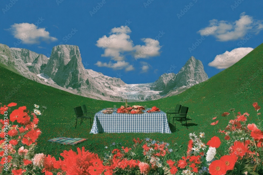 Naklejka premium Picnic table in surreal mountain valley with wildflowers