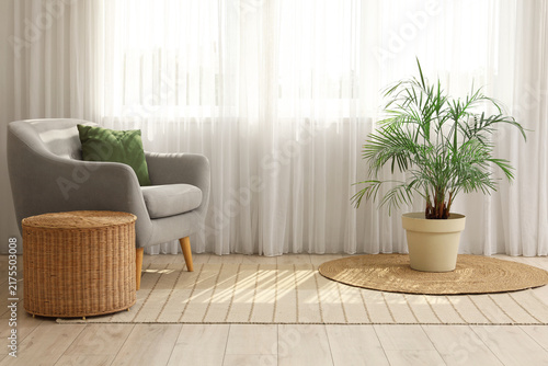Interior design and home comfort, cozy living room corner with grey armchair ...