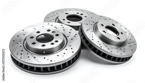 Three automotive braking components featuring a circular design with multiple drilled holes, showcasing a metallic finish against a white backdrop