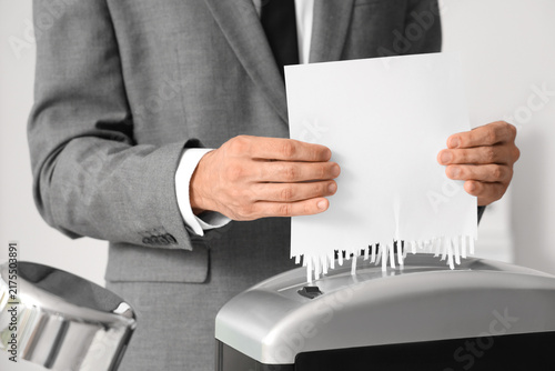 Obraz na plátně Data privacy and document security, businessman shredding confidential paper doc