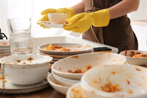 Foto Household chores and domestic burnout, person wearing yellow rubber gloves washi