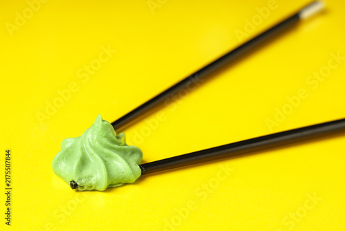 Canvastavla Portion of tasty wasabi with chopsticks on yellow background