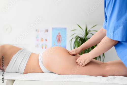 Young woman getting anti-cellulite massage in clinic