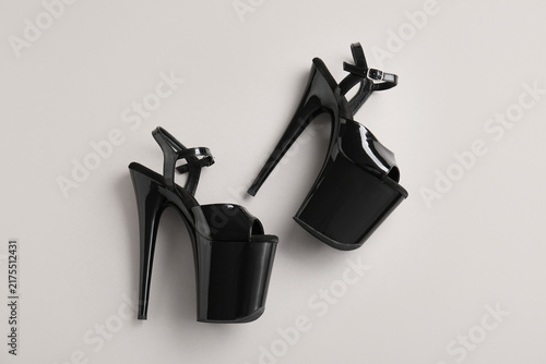 Fotografie Stylish black high heels for pole dance on grey background