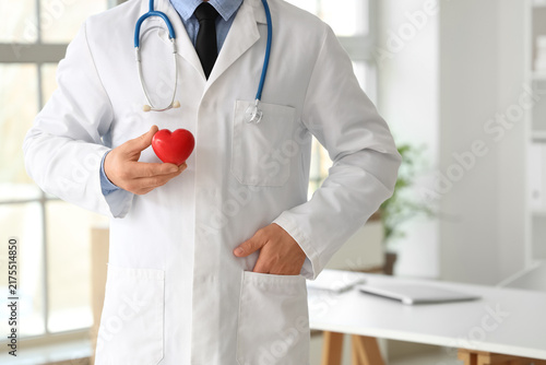 Male doctor with heart in clinic