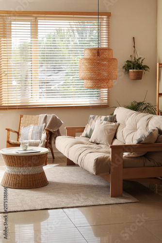 Fotografie Interior of living room with comfortable sofa, coffee table, armchair and lamp