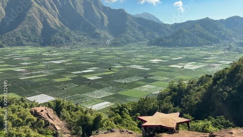Green Agricultural Valley Surrounded by Mountain Slopes

