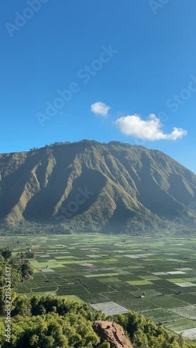 Dramatic Green Mountain Ridge Under a Blue Sky

