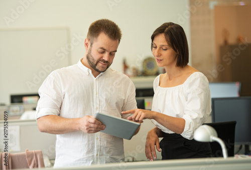 Photography two professional people employees working together in the office discussing deve