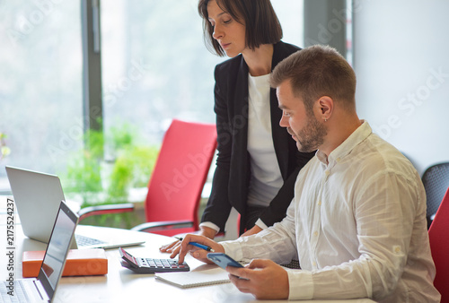 Canvas Print two professional people employees working together in the office discussing deve