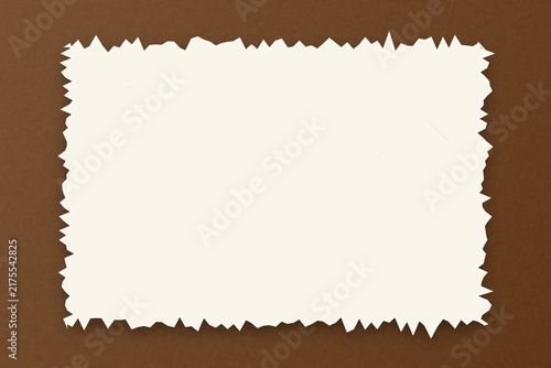 Rectangular white paper frame with a jagged edge on solid brown background.