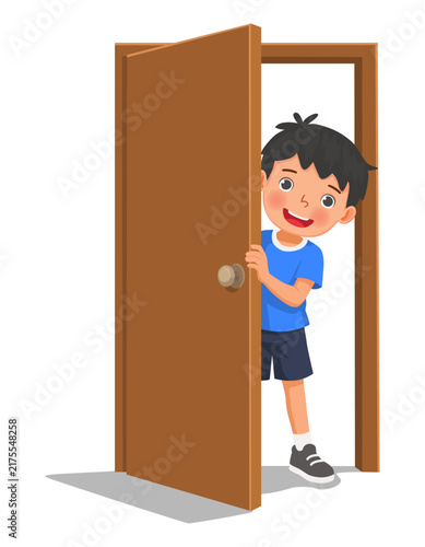 Little boy open door peeking from behind a half opened door