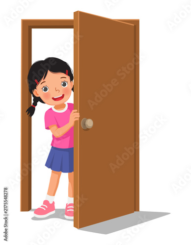 Little girl open door peeking from behind a half opened door