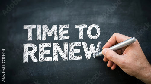 Hand writing renewal message on blackboard