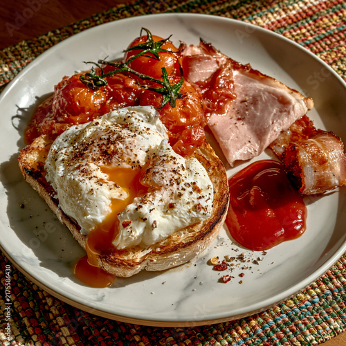 a plate of breakfast food viewed from a high angle. the white plate has a subtle marble texture
