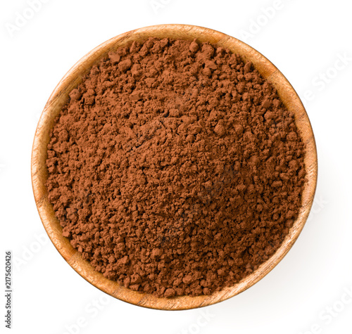 Raw cocoa powder in the wooden bowl, isolated on white background, top view.