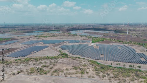 Aerial View of Solar Panel Farm and Wind Turbines Generating Renewable Clean Energy