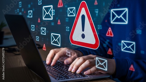 Cybersecurity warning concept with laptop, alert symbol and digital email threats