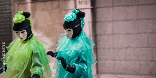two colorful mimes play in the streets of the city during the carnival days