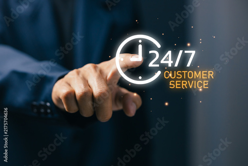 Obraz na plátne Business professional touching 24/7 customer service icon, representing online support, help desk, contact center, assistance, communication, availability, and digital service technology
