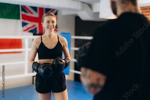 Obraz na plátně Woman boxer training with coach in ring