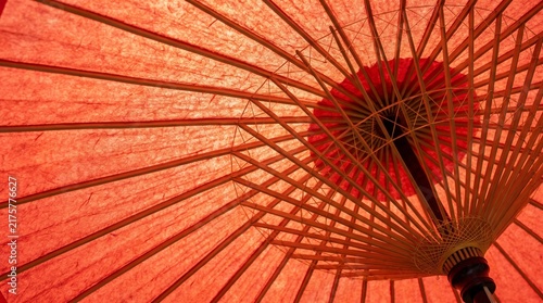 Inside of red wagasa umbrella with bamboo ribs backlit craft detail macro photo japan