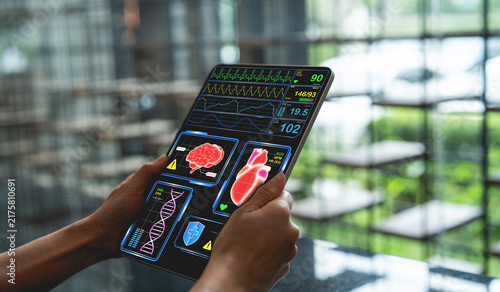 Person holding digital tablet displaying medical data, including heart rate, brain activity, and DNA analysis, in modern setting