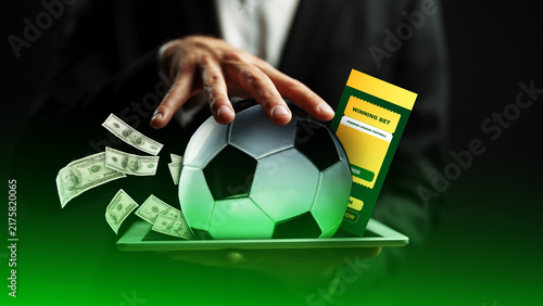 Obraz na płótnie Betting on a sport with a soccer ball and cash displayed during a game in a spor