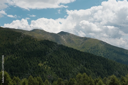 Green Mountain Range Under Cumulus Clouds