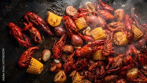 Traditional Louisiana crawfish boil with corn and potatoes, steaming hot cajun seafood feast, rustic outdoor mudbug dinner
