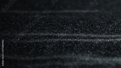 Close Up Textured Surface Shimmering with Tiny Light Dots in Dark Setting