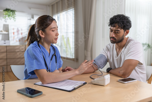 Принти на полотні Healthcare professional measuring male patient blood pressure during medical checkup, monitoring vital signs while recording results for preventive care, health assessment, patient wellness