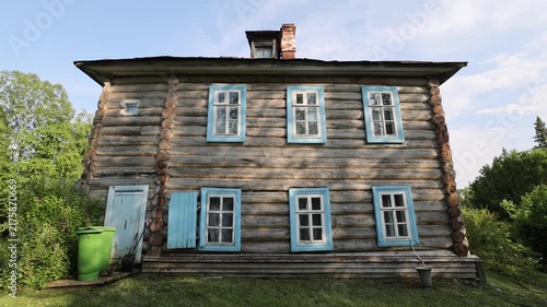View of traditional Russian log house with blue window frames on the Solovetsky Islands in Solovetsky, Arkhangelsk Oblast, Russia.