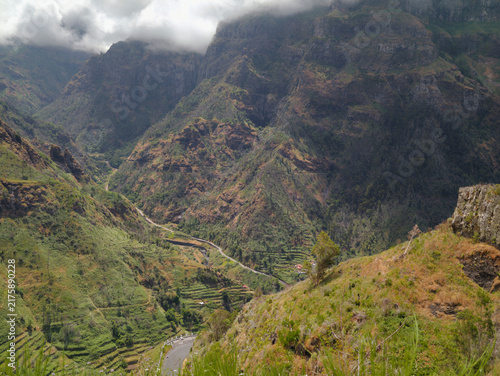Konstfotografi Scenic aerial view of a deep green valley surrounded by steep rocky mountains
