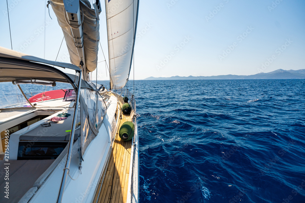 Fototapeta premium Sailing yacht cruising across the Adriatic Sea under full sail. Freedom and adventure during a long distance sailing voyage.