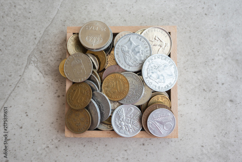 Obraz na plátne Wood cox of much old gold and silber coins on the natural background