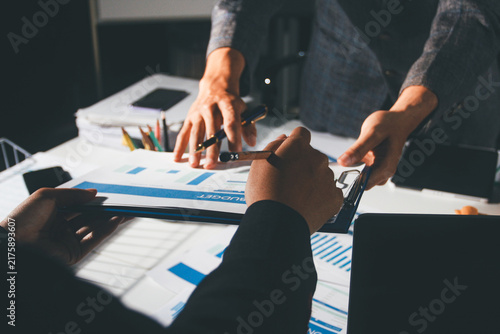 Professional photo of a person's hands reviewing a contract or legal document on a desk, for concepts of business, finance, and legal affairs
