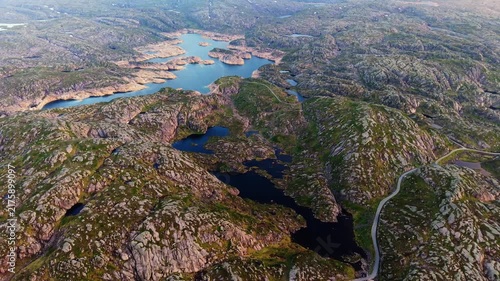 drone view over the rocky highlands and large reservoirs nestled in the barren terrain of Lysebotn, Norway
