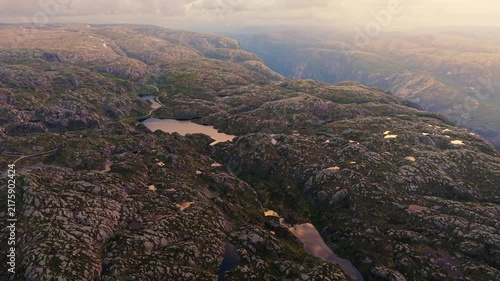 drone panorama over the barren rocky highlands and Lysevegen road approaching the famous Lysebotn curves in Rogaland, Norway