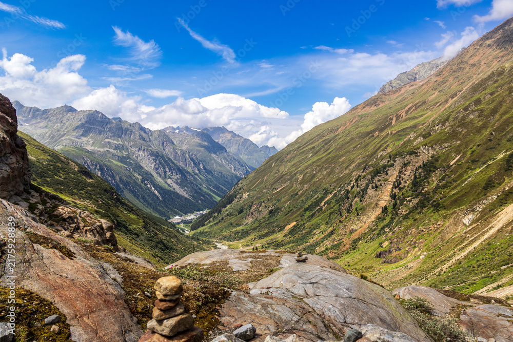 Fototapeta premium Mountain valley landscape with rocky trail and blue sky, Austria, Tyrol, Mittelberg, Pitztal, 29 June 2026