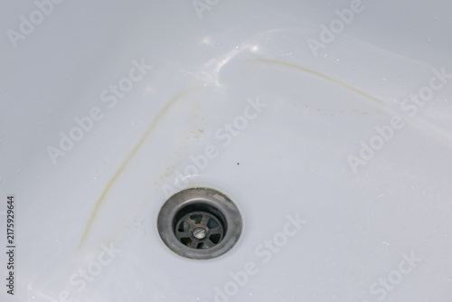 Konstfotografi Bathtub drain showing yellow stain on white enamel