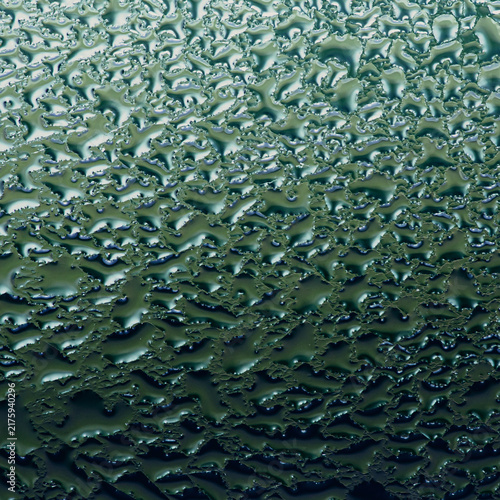 Condensation creating abstract water droplet texture on glass