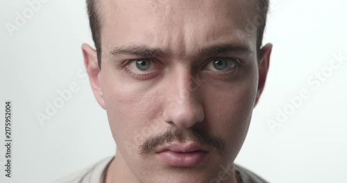 Extreme Close-up of Young Man with Confused and Skeptical Face Expression on White Background