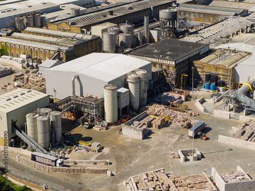 Aerial View of a Busy Paper Mill Facility During a Sunny Day With Stacks of Recycled Material Piles