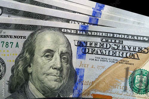 Bild auf Leinwand Close-up of fresh hundred-dollar bills inside a wallet, symbolizing wealth and s