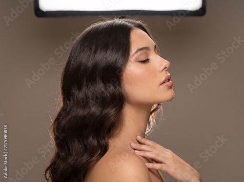 Beautiful Young Woman with clean, fresh skin. Facial treatment. Cosmetology, beauty, and spa. A nice and attractive girl with a pleasant smile.	