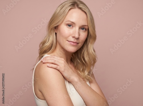 Beautiful Young Woman with clean, fresh skin. Facial treatment. Cosmetology, beauty, and spa. A nice and attractive girl with a pleasant smile.	