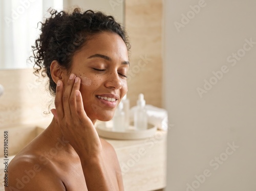 Beautiful Young Woman with clean, fresh skin. Facial treatment. Cosmetology, beauty, and spa. A nice and attractive girl with a pleasant smile.	